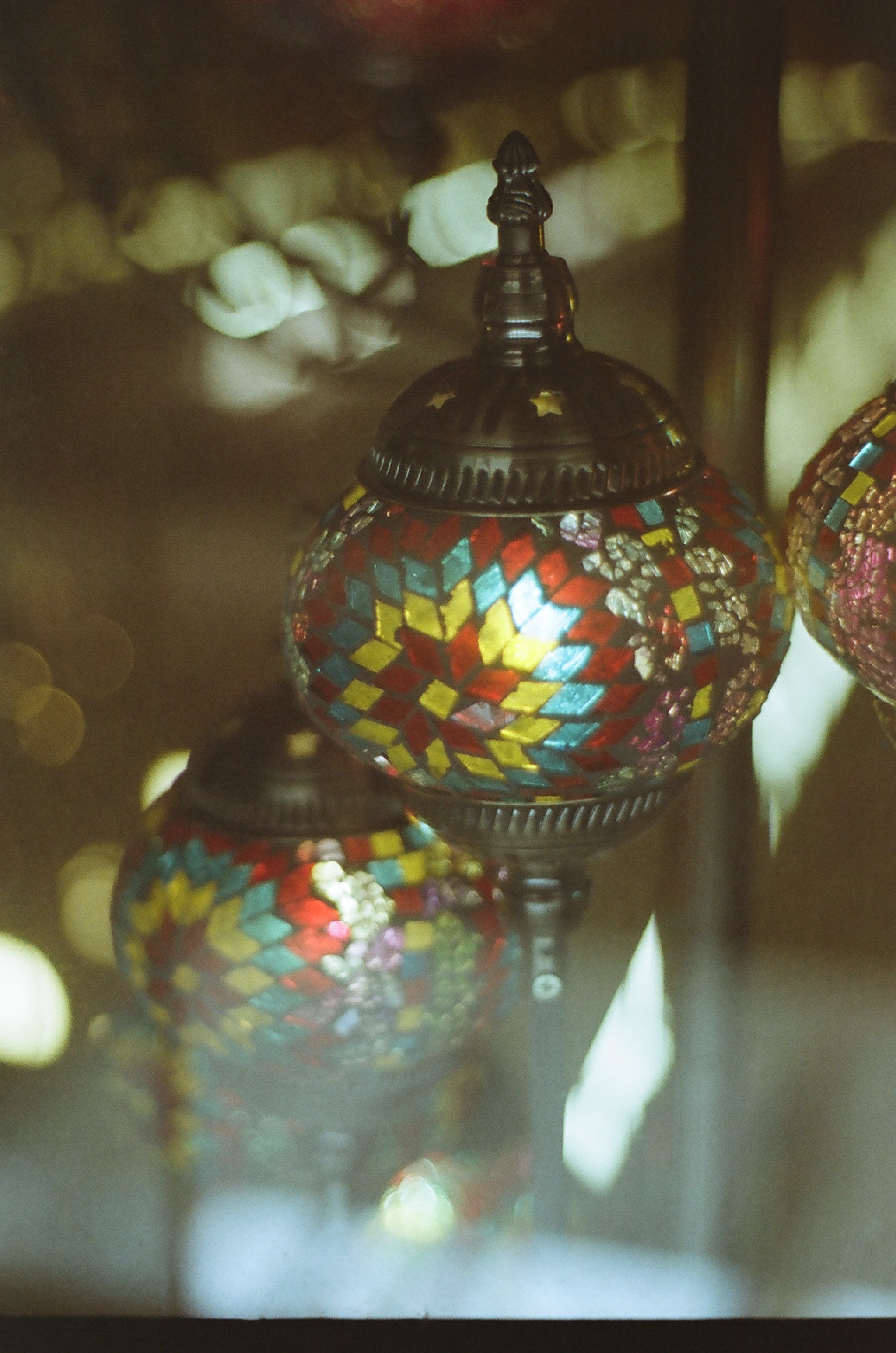 Closeup of a stained glass lantern in a store window.